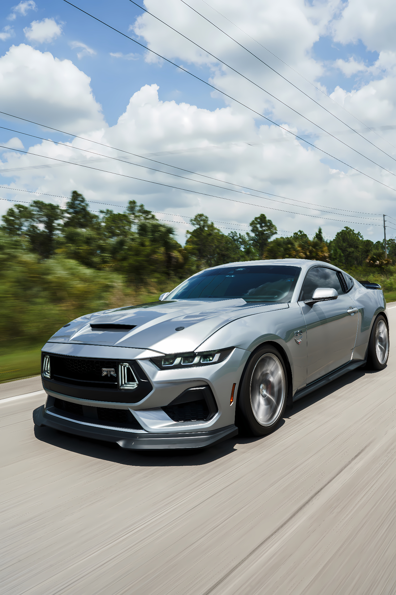 Silver Mustang GT driving front three-quarter with HP1000 emblem installed