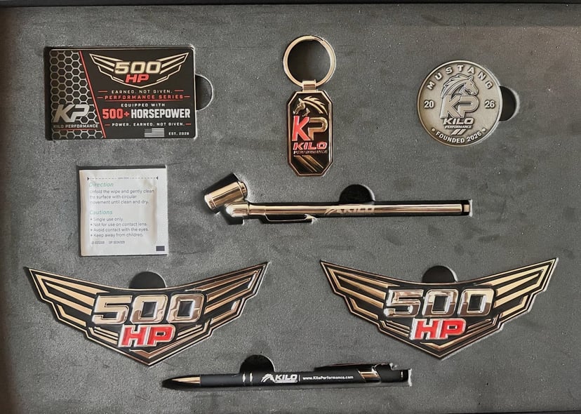 500 HP Collector Kit — contents: two winged emblems, Kilo Performance collector card, keychain, challenge coin, tool and pen